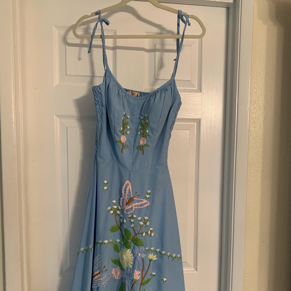 Blue spaghetti strap dress with floral design. Worn a few times,has a few stains